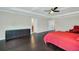Primary bedroom featuring tray ceilings, dark hardwood floors, and lots of space at 1281 Gatewood Ave, Minneola, FL 34715