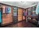 Spacious walk-in closet featuring custom wood shelving, drawers and ample storage space at 1281 Gatewood Ave, Minneola, FL 34715