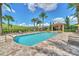 Inviting community pool area with comfortable lounge chairs, a pool house, and lush landscaping at 1281 Gatewood Ave, Minneola, FL 34715