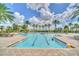 Large community swimming pool with lounge chairs and shaded seating, perfect for relaxation and recreation at 1281 Gatewood Ave, Minneola, FL 34715