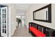 Elegant foyer with tiled flooring, decorative mirror, and a view of the staircase and living spaces at 1281 Gatewood Ave, Minneola, FL 34715