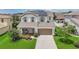 Beautiful two-story home with solar panels, well-manicured lawn, and tasteful landscaping during the day at 1281 Gatewood Ave, Minneola, FL 34715