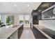 Modern kitchen with stainless steel appliances, island with seating, and lots of counter space at 1281 Gatewood Ave, Minneola, FL 34715