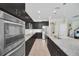 Spacious kitchen features stainless appliances, a large island, and sleek dark cabinetry at 1281 Gatewood Ave, Minneola, FL 34715