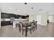 Stylish kitchen featuring dark cabinets, island with seating, and tile floors at 1281 Gatewood Ave, Minneola, FL 34715