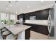 Kitchen island features granite countertops and sleek stainless steel appliances at 1281 Gatewood Ave, Minneola, FL 34715