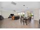 Open-concept living and dining area with tile flooring and sliding glass doors at 1281 Gatewood Ave, Minneola, FL 34715