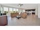 Bright living room featuring tiled flooring, a sectional sofa, and an open view into the modern kitchen at 1281 Gatewood Ave, Minneola, FL 34715