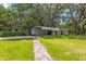Lush backyard with a carport, storage shed and beautiful trees, offering ample space and storage solutions at 13050 Se 120Th St, Ocklawaha, FL 32179