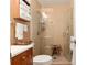 Modern bathroom with glass enclosed shower, wood vanity, updated fixtures, and neutral finishes at 13050 Se 120Th St, Ocklawaha, FL 32179
