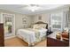 Cozy bedroom featuring neutral walls, a ceiling fan, a double bed, and access to outdoor patio at 13050 Se 120Th St, Ocklawaha, FL 32179