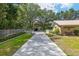 Long driveway leading to a charming home with mature trees and manicured landscaping for curb appeal at 13050 Se 120Th St, Ocklawaha, FL 32179