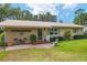Inviting front entrance with brick accents, quaint seating, and well-maintained landscaping at 13050 Se 120Th St, Ocklawaha, FL 32179