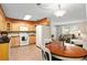 Eat-in kitchen with maple cabinets, modern appliances, and a view to the living room at 13050 Se 120Th St, Ocklawaha, FL 32179