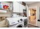 Convenient laundry room with side-by-side washer and dryer and extra storage space at 13050 Se 120Th St, Ocklawaha, FL 32179