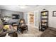 Cozy living room with wood flooring, French doors leading to another room, and neutral wall colors at 13050 Se 120Th St, Ocklawaha, FL 32179