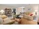 Open-concept living room with tiled flooring, neutral decor, and ample seating at 13050 Se 120Th St, Ocklawaha, FL 32179