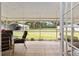 Screened patio offers outdoor dining space and serene views of the expansive, green backyard at 13050 Se 120Th St, Ocklawaha, FL 32179