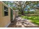 Outdoor shed featuring durable siding, green door, and adjacent grassy space for convenient storage at 13050 Se 120Th St, Ocklawaha, FL 32179