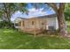 Backyard features a privacy screen and ample yard space with mature trees at 1358 E Schwartz Blvd, The Villages, FL 32159