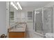 Bright bathroom featuring a double vanity with granite countertop and a tiled walk-in shower at 1358 E Schwartz Blvd, The Villages, FL 32159