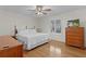 Bedroom with hardwood floors, ceiling fan and a window with plantation shutters at 1358 E Schwartz Blvd, The Villages, FL 32159