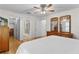 Spacious bedroom featuring hardwood floors and views of an ensuite bathroom and walk-in closet at 1358 E Schwartz Blvd, The Villages, FL 32159