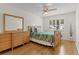 Cozy bedroom with tropical themed decor, ceiling fan and natural light at 1358 E Schwartz Blvd, The Villages, FL 32159