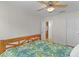 Cozy bedroom with tropical themed decor, ceiling fan and wooden floors at 1358 E Schwartz Blvd, The Villages, FL 32159
