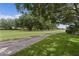 Scenic community green space with mature trees and walking path on a sunny day at 1358 E Schwartz Blvd, The Villages, FL 32159