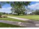 Picturesque community with expansive green space, mature trees, and walking path at 1358 E Schwartz Blvd, The Villages, FL 32159