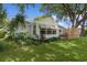 Charming home with lush greenery and a well-manicured lawn and a modern privacy screen at 1358 E Schwartz Blvd, The Villages, FL 32159