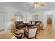 Inviting living room boasting hardwood floors, large windows, and comfortable leather sofas and chairs at 1358 E Schwartz Blvd, The Villages, FL 32159