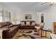 Inviting living room featuring hardwood floors, comfortable sofas and chairs, and a ceiling fan at 1358 E Schwartz Blvd, The Villages, FL 32159