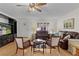 Inviting living room boasting hardwood floors, large windows, and comfortable leather sofas and chairs at 1358 E Schwartz Blvd, The Villages, FL 32159