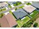 An aerial view showcases the home's roof, backyard, and its position among neighboring properties at 1409 Gatlin Pl, The Villages, FL 32163