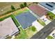 Aerial view of the house highlighting roof, manicured backyard, and neighborhood at 1409 Gatlin Pl, The Villages, FL 32163