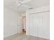 Bedroom with a ceiling fan and double door closet at 1409 Gatlin Pl, The Villages, FL 32163