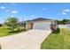Charming single-story home with a two-car garage and a well-maintained lawn at 1409 Gatlin Pl, The Villages, FL 32163