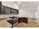 Well-equipped kitchen with stainless steel appliances and counter space overlooking the living area at 1409 Gatlin Pl, The Villages, FL 32163