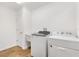 Laundry room featuring a utility sink and modern appliances at 1409 Gatlin Pl, The Villages, FL 32163