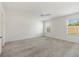 A bright main bedroom featuring neutral carpet, ceiling fan, and two windows at 1409 Gatlin Pl, The Villages, FL 32163