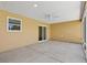A covered screened patio featuring concrete floors, a ceiling fan, and sliding door access to the home at 1409 Gatlin Pl, The Villages, FL 32163