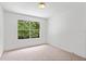 Comfortable bedroom with a large window showcasing a view of greenery at 1413 Silverthorn Dr, Orlando, FL 32825