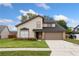 Charming two-story home featuring a well-manicured lawn and an attached two-car garage at 1413 Silverthorn Dr, Orlando, FL 32825