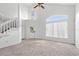 Bright living room with high ceilings, neutral carpet, lots of natural light, and a staircase at 1413 Silverthorn Dr, Orlando, FL 32825