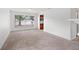 Bright living room with neutral carpet and a large window overlooking the front yard at 1413 Silverthorn Dr, Orlando, FL 32825