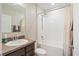 Bright bathroom featuring a shower-tub combo, vanity with sink, and neutral wall color at 15287 Aquarius Way, Mascotte, FL 34753