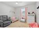 Cozy Bedroom with crib, plush chair, and ample storage for a warm, inviting space at 15287 Aquarius Way, Mascotte, FL 34753