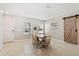 Bright dining room with a sliding barn door and tile flooring at 15287 Aquarius Way, Mascotte, FL 34753